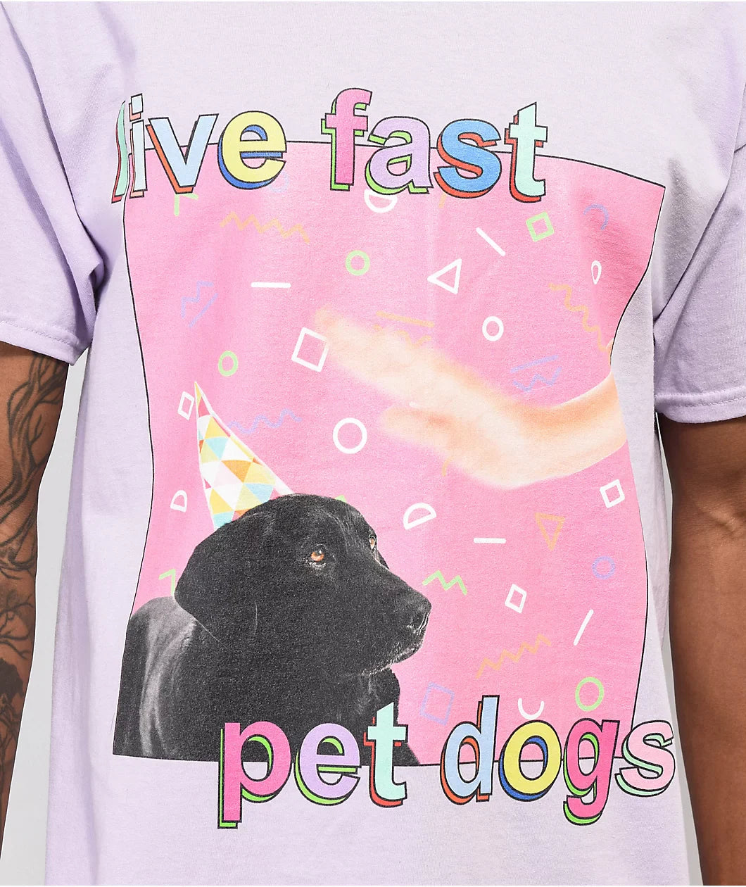 T-shirt with a black dog, colorful text, and geometric shapes on a pink background