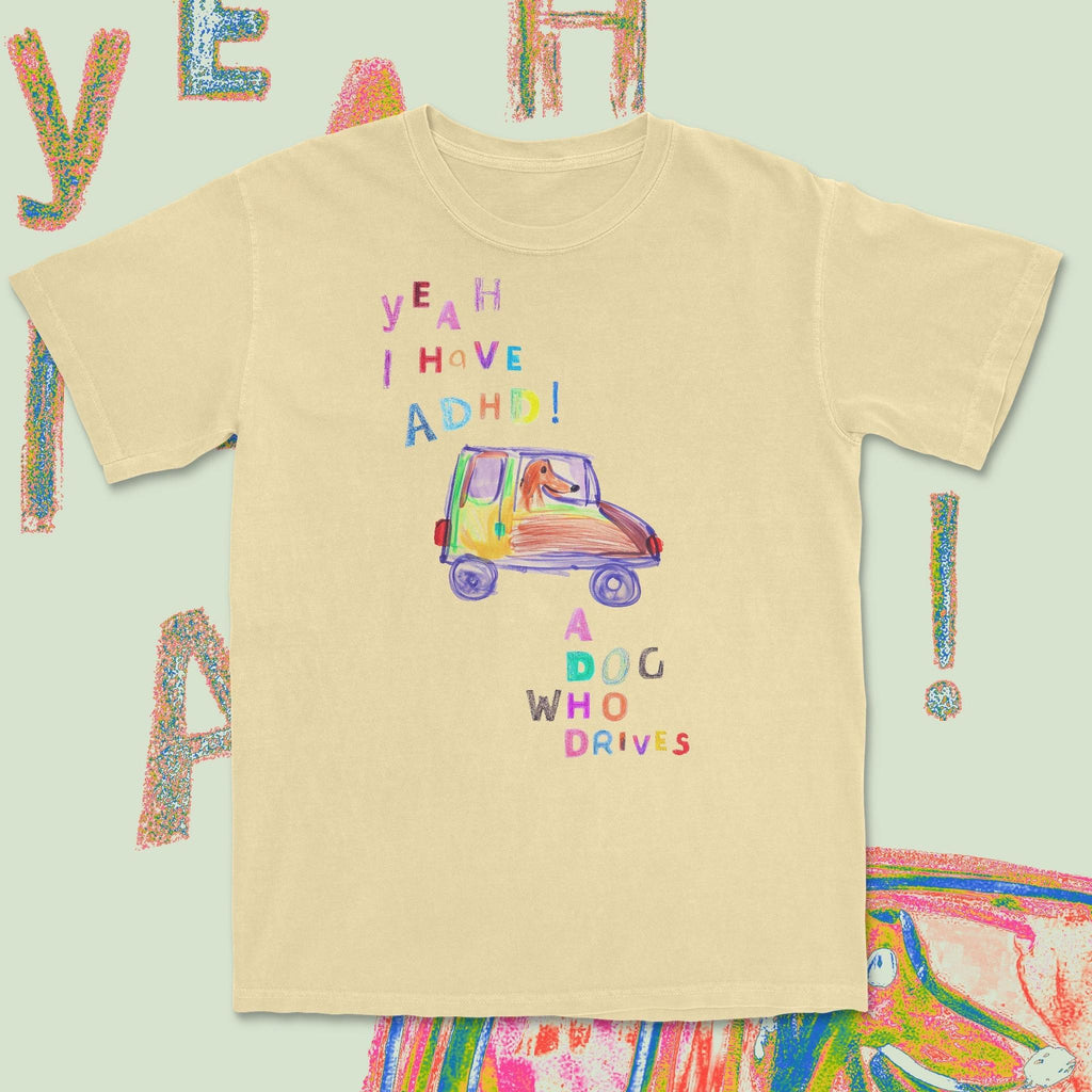 Beige t-shirt with colorful text and car illustration on a light green background